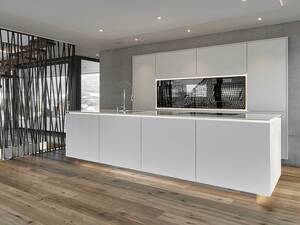 Die grifflosen Fronten unterstreichen den minimalistischen Stil der Küche. Bei der schwebend wirkenden Arbeitsplatte handelt es sich um den Kunststein «Silestone Blanco Zeus». Furrer Küchen AG.